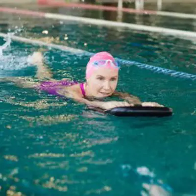 Adult using flutter board in pool