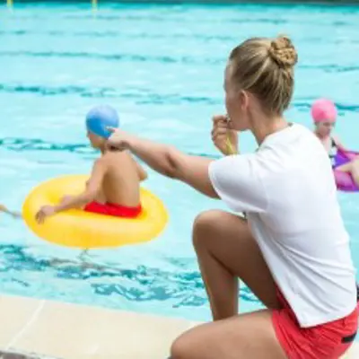 lifeguard and children at pool