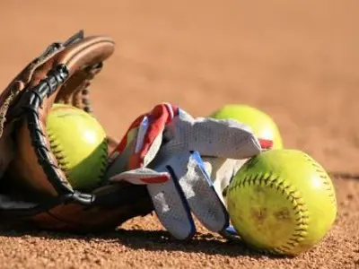 softball glove lying on softball diamond