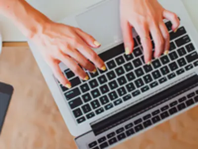 Person typing on laptop
