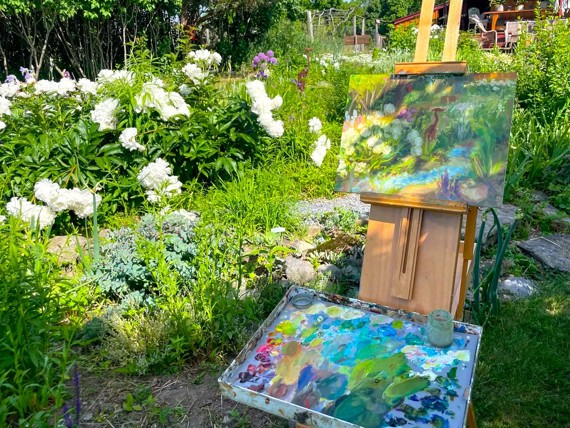 artist easel in garden with painting