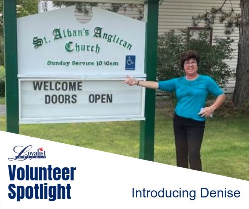 lady standing beside St. Albans Anglican Church sign