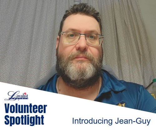 Man with brown hair. glasses and beard