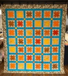 multi-coloured quilt featuring stars
