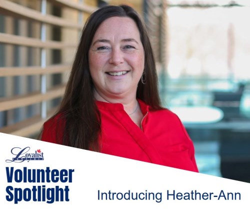 Smiling lady with long brown hair and red shirt